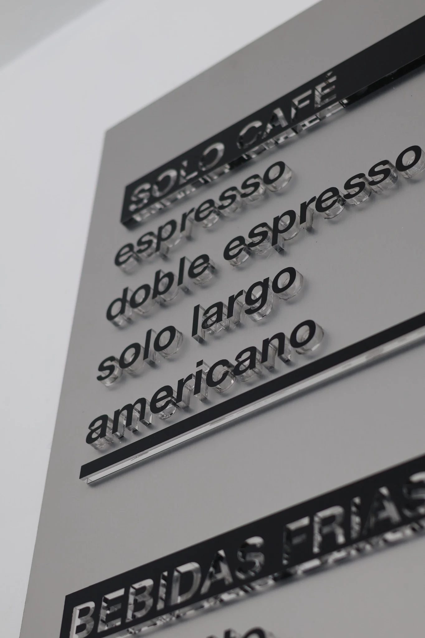 Typographic menu lettering mounted on the café wall.